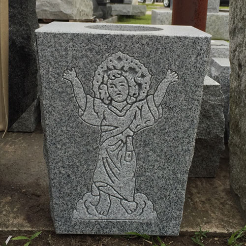 A grey granite vase carved with a figure in relief